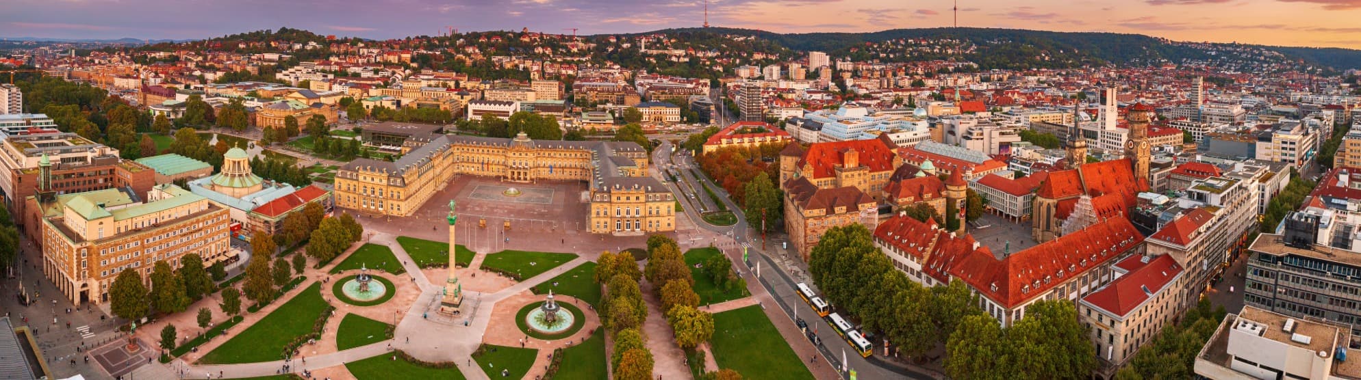 Aerial view of Stuttgart city center with a castle in a courtyard at sunset