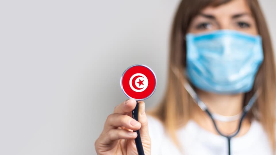 The healthcare system in Tunisia - A doctor holds a stethoscope toward the camera