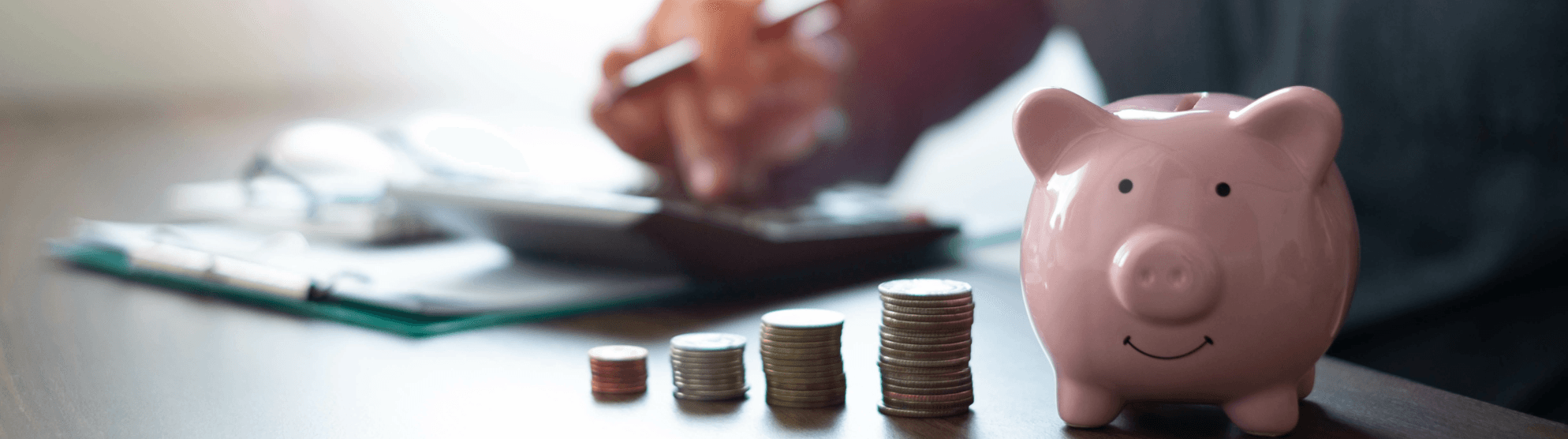 Piggy bank and coin stacks symbolizing moving money-saving tips