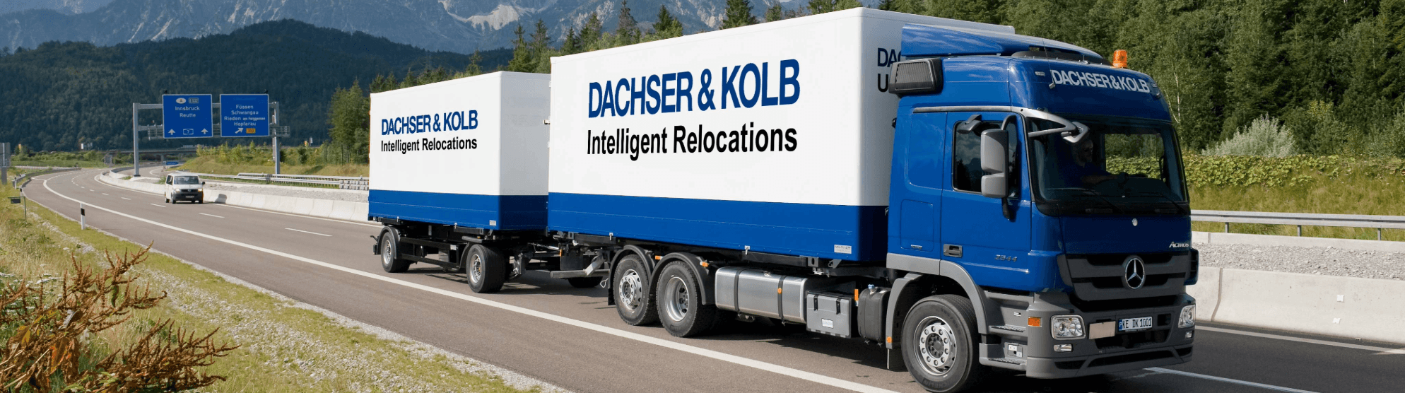 Moving company truck on the highway – DACHSER & KOLB provides professional relocation services.
