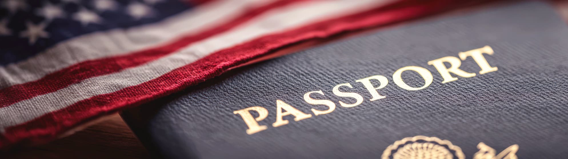 US passport under the American flag – symbolizing essential visa and entry documents for moving to the USA.