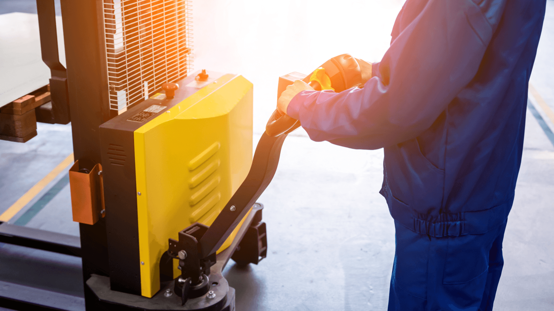 Worker operating electric pallet jack – preparing goods for LCL (Less than Container Load) shipment in warehouse