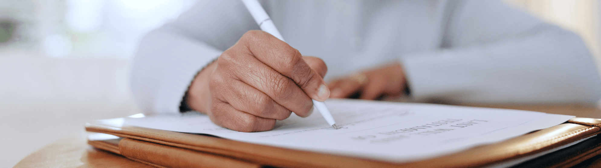 Hand signing apartment application – accessible and user-friendly support for filling out housing documents