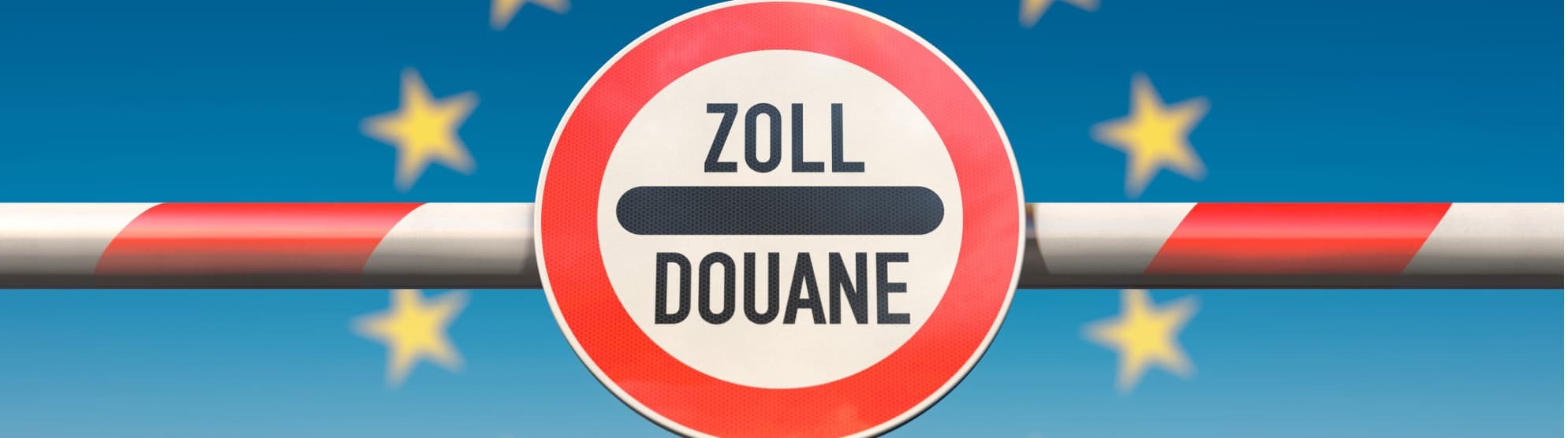 Customs barrier with “Zoll/Douane” sign in front of EU flag, symbol for customs Thailand to Germany.