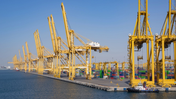 Large container port Jebel Ali in the UAE with yellow cranes and shipping containers for overseas moving with DACHSER & KOLB.