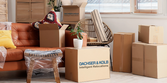 Wohnzimmer mit verpackten Möbeln und Kartons – Symbolbild für professionelle Neumöbellogistik