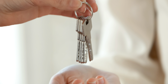 Übergabe von Wohnungsschlüsseln – symbolisch für Einzug und Tipps für die erste eigene Wohnung
